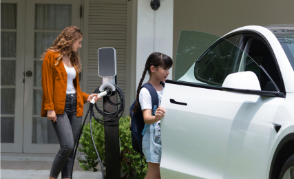 Daughter & Mother charging electric vehicle at home
