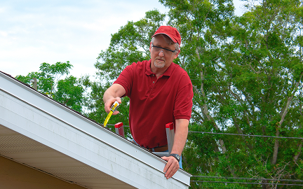 Man inspecting house during home solar consultation
