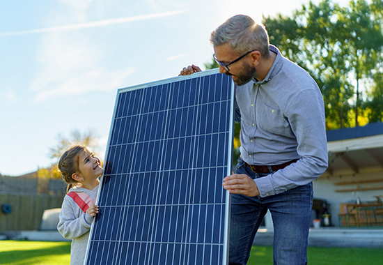 Family inspecting solar panel