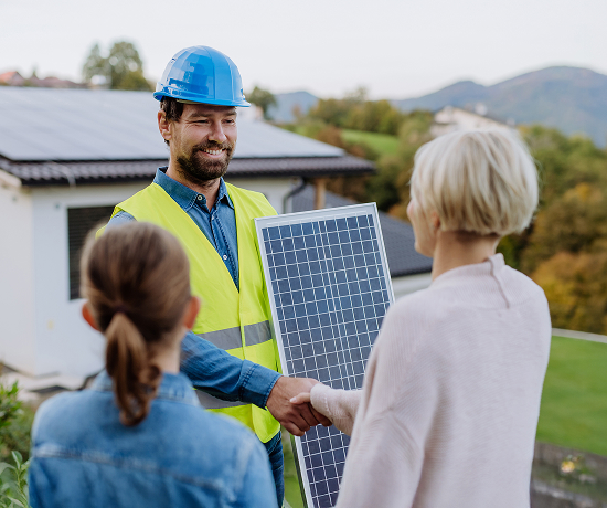 Home owner shaking hands with solar installer