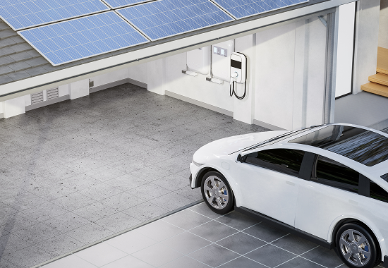 Electric vehicle pulling into a garage ready to be chargered with at home charger